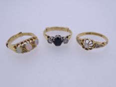 THREE 18CT GOLD DRESS RINGS to include a diamond set example with openwork flower head and leaf