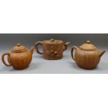 THREE CHINESE YIXING TEAPOTS WITH COVERS, 12cms H the tallest