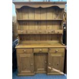 REPRODUCTION PINE INVERTED BREAKFRONT DRESSER having a two shelf rack with central spice drawers