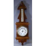 ANEROID BAROMETER IN CARVED OAK FRAME