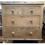 VICTORIAN STRIPPED PINE CHEST of two short over two long drawers with turned wooden knobs and bun