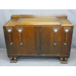ART DECO OAK SIDEBOARD with railback and stepped top over an arrangement of four cupboard doors,