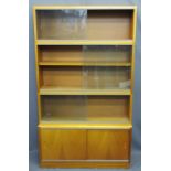 SIMPLEX MID-CENTURY SECTIONAL STACKING BOOKCASE, the base section with sliding wooden doors, the