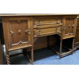 JACOBEAN STYLE RAILBACK SIDEBOARD, the panelled rail with arched carved detail over a base of two