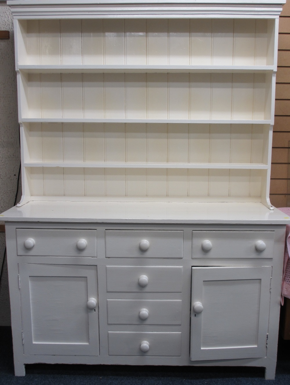 LATE VICTORIAN PAINTED PINE DRESSER having a three shelf rack over a T arrangement of three frieze