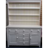 LATE VICTORIAN PAINTED PINE DRESSER having a three shelf rack over a T arrangement of three frieze