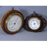 TWO WALL HANGING CARVED BAROMETERS, 29cms diameter the larger