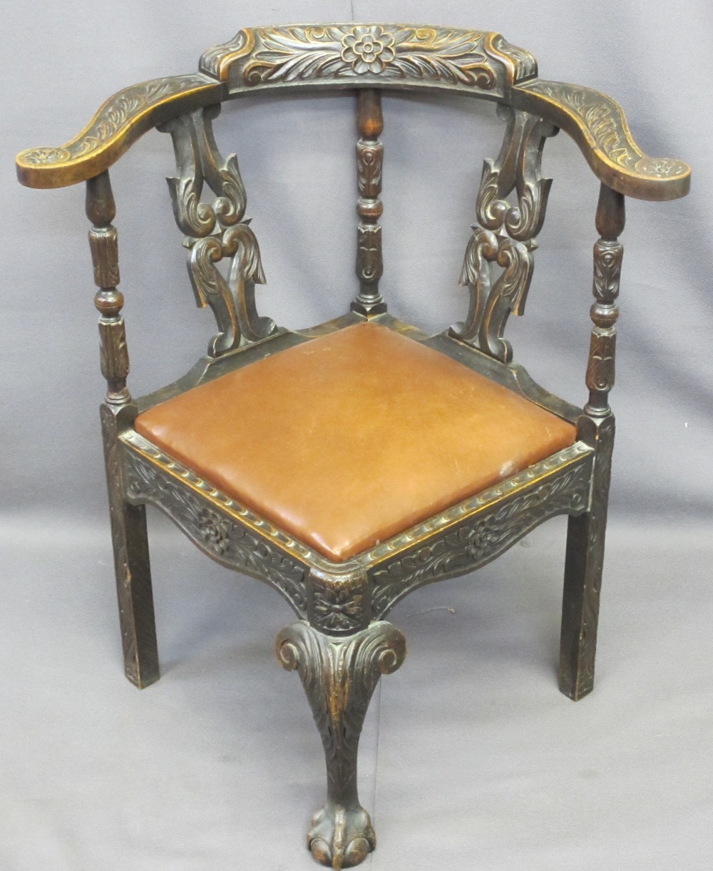 JACOBEAN STYLE CARVED OAK CORNER ARMCHAIR with drop-in rexine covered seat pad, 79cms H, 73cms W,