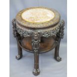 CHINESE CARVED HARDWOOD CIRCULAR STAND with pink marble inset top and under tier shelf, 68cms H,