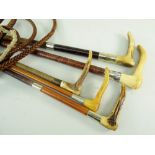 FIVE VINTAGE HUNTING CROPS / WHIPS, three with antler handles, one with silver collar, two steel