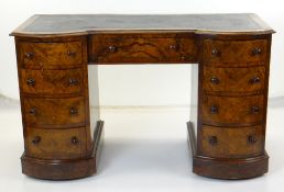 VICTORIAN WALNUT PEDESTAL DESK with bowed pedestals of four drawers each, central frieze drawer,