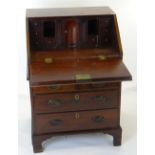 GEORGE II MAHOGANY BUREAU of small proportions, moulded rectangular fall with engraved escutcheon,