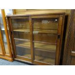 VINTAGE OAK BOOKCASE, glazed sliding doors with flush metal handles, plinth base, 122cms wide