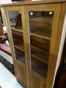 MODERN OAK CABINET with half glazed doors, 180cms high