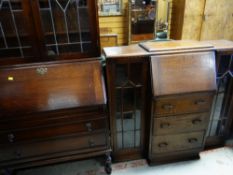 TWO EARLY 20TH CENTURY OAK BUREAU BOOKCASES, one with leaded doors, 200cms high the other with