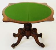 MID-VICTORIAN CARVED WALNUT SERPENTINE CARD TABLE, foldover top above baluster column and four