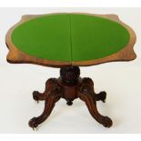 MID-VICTORIAN CARVED WALNUT SERPENTINE CARD TABLE, foldover top above baluster column and four