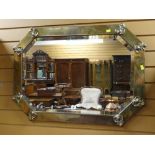 EARLY 20TH CENTURY BRASS FRAMED CANTED RECTANGULAR WALL MIRROR, 88cms wide