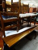 REPRODUCTION OAK TRESTLE DINING TABLE, four oak chairs similar and a mahogany coffee table with