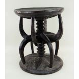 NRI-AWKA PRESTIGE STOOL, with carved spindle and claw column support, 34.5cms diam. Condition