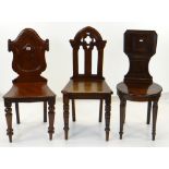 THREE VICTORIAN HALL CHAIRS, with turned front legs and solid seats, variously with Gothic, tablet