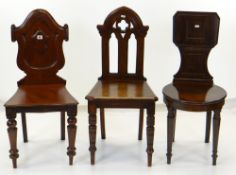 THREE VICTORIAN HALL CHAIRS, with turned front legs and solid seats, variously with Gothic, tablet