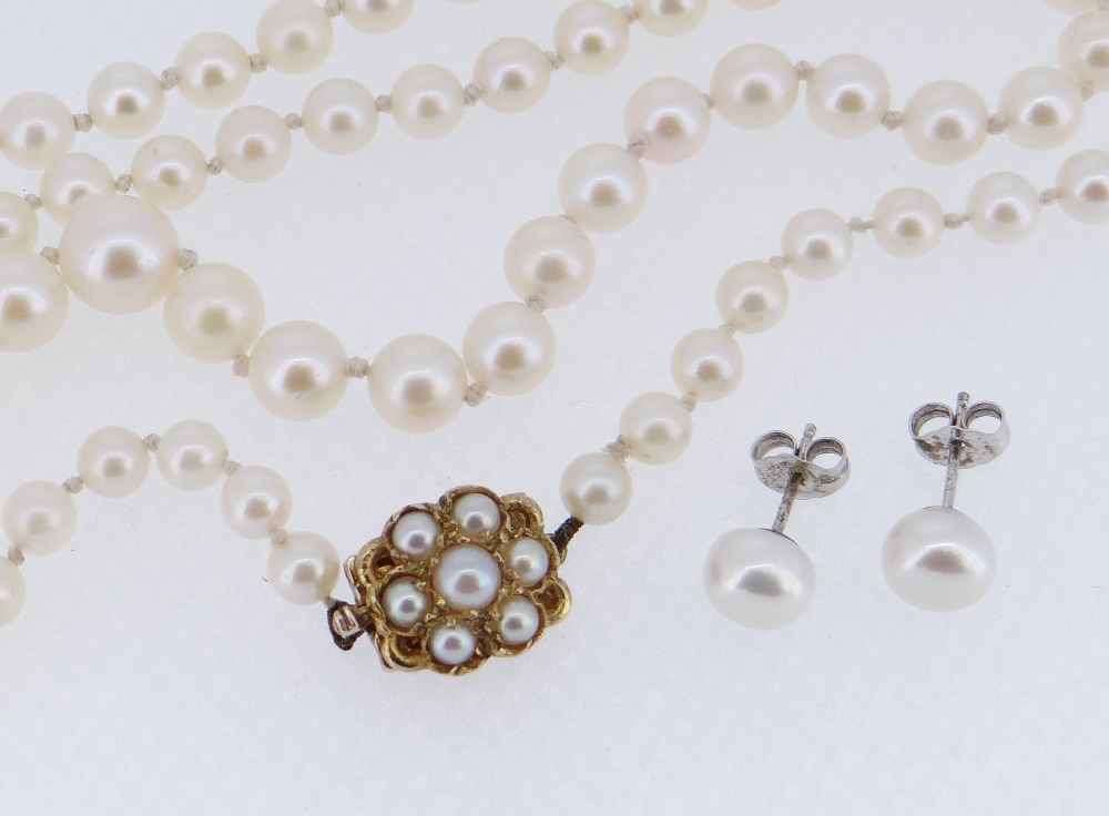 STRING OF CULTURED PEARLS having 9ct gold pearl set flower head clasp together with pair of silver