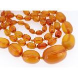 LONG STRING OF GRADUATED AMBER BEADS, from 30mm to 10mm, overall 130cm long, gross weight 98gms