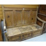 EARLY 19TH CENTURY PINE BOX SETTLE, with panelled back and down swept arms, hinged seat section,