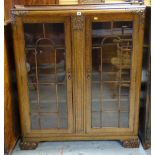 1930s OAK BOOKCASE with astragal glazed doors and foliate carved ornament, 106 x 35 x 128cms