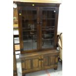 NIGEL GRIFFITHS STAINED OAK BOOKCASE, with leaded glazed doors and cupboard base, 92 x 152cm