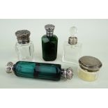 FOUR VICTORIAN SILVER MOUNTED CUT GLASS SCENT BOTTLES, comprising a green double ended bottle,