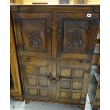 NIGEL GRIFFITHS STAINED OAK DRINKS CABINET, with two Flemish style carved panels of monks above