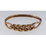 9CT GOLD LADIES BANGLE of interweaving design, 8.1gms