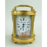 SMALL GILT BRASS & ENAMEL BOUDOIR CARRIAGE TIMEPIECE BY ELLIOTT & SONS, decorated with Cupid by