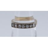 YELLOW METAL SEVEN STONE DIAMOND RING totaling 0.28cts overall approximately (visual estimate), size