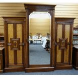 GOOD LATE VICTORIAN 'AESTHETIC' STYLE TRIPLE WARDROBE, floral carved panelled cupboards with brass