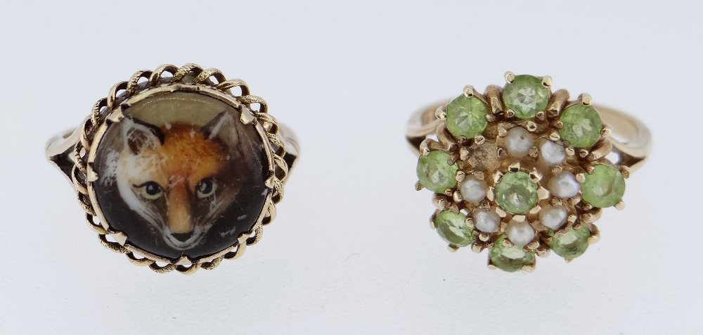 TWO 9CT GOLD RINGS one set with peridot and seed pearls, size M, the other decorated with fox