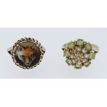 TWO 9CT GOLD RINGS one set with peridot and seed pearls, size M, the other decorated with fox