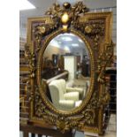 MODERN ITALIAN-STYLE GILT COMPOSITION MOULDED MIRROR, decorated with flowers, 144cms high