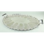 EDWARDIAN ELECTROPLATED OVAL TEA TRAY, BY DANIEL & ARTER, with wavy rim and turned ebony handles,