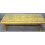 AN EASTERN HEAVILY CARVED LONG-JOHN COFFEE TABLE with a glazed top, 50cms H, 150cms W, 56cms D