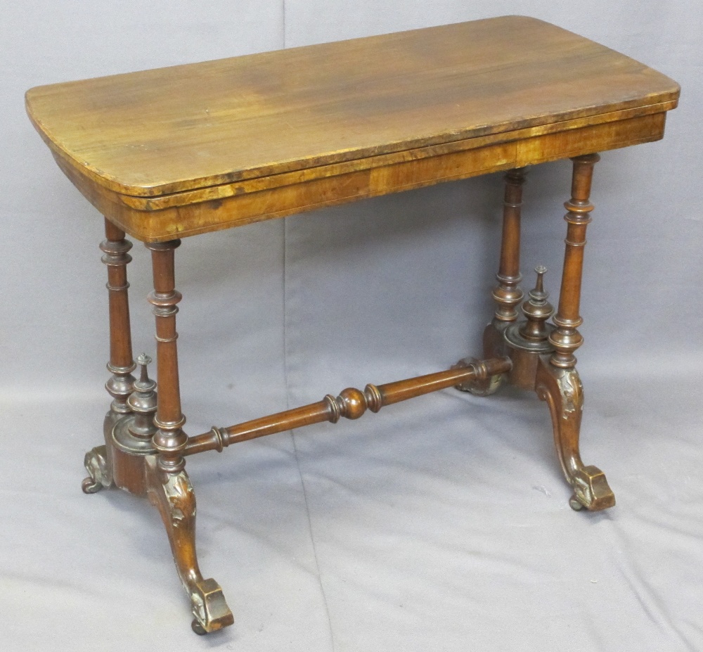 VICTORIAN WALNUT FOLDOVER CARD TABLE on turned columns and four splayed feet with cross stretcher,