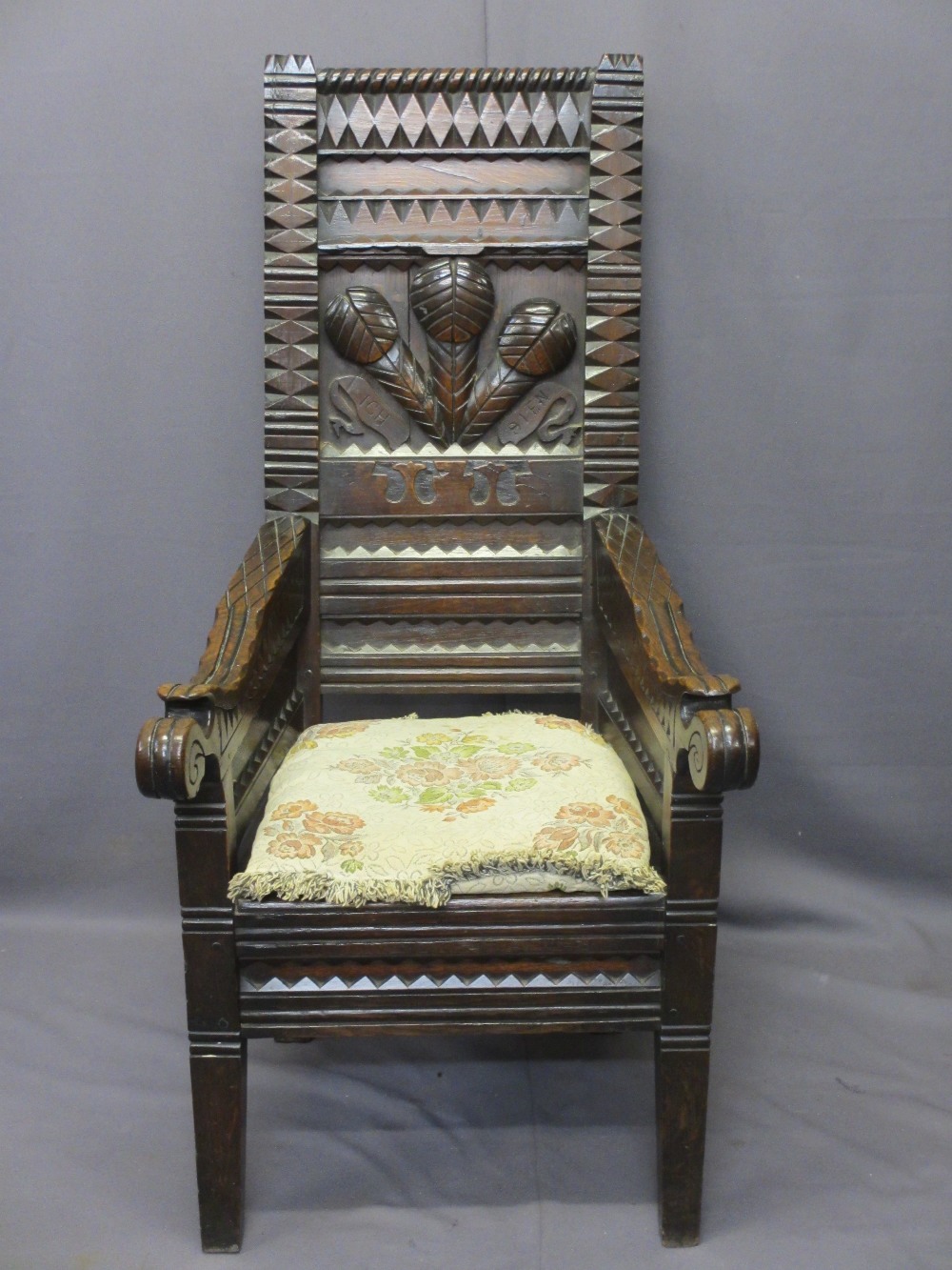 HEAVILY CARVED WELSH EISTEDDFOD TYPE CHAIR, three feathers and 'Ich Dien' carved to the back
