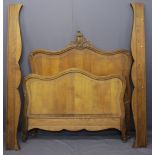 CONTINENTAL OAK 4FT 6INS BED FRAME, the shaped head and foot boards with carved detail, 159cms H,