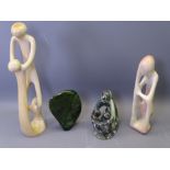 FOUR CARVED SOAPSTONE SCULPTURES to include three group or figural ornaments and a green face mask