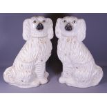 LARGE PAIR OF WHITE STAFFORDSHIRE SEATED SPANIELS, 38cms H (A/F)