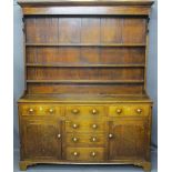 CIRCA 1820 NORTH WALES OAK DRESSER with a three shelf rack over a T arrangement of six pine lined