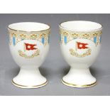 WHITE STAR LINE EGG CUPS, a pair, probably reproduction R D No 334028 and 'Titanic 1912' printed