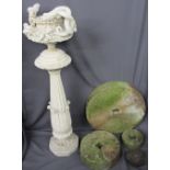THREE STONE GRINDING WHEELS, composition planter on stand and an iron cannonball remnant, the